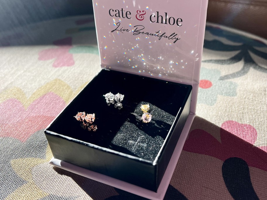 three pairs of earrings in gift box sparkling in sun