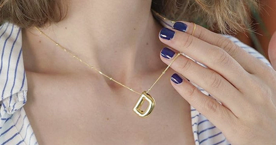 woman wearing letter D gold necklace 