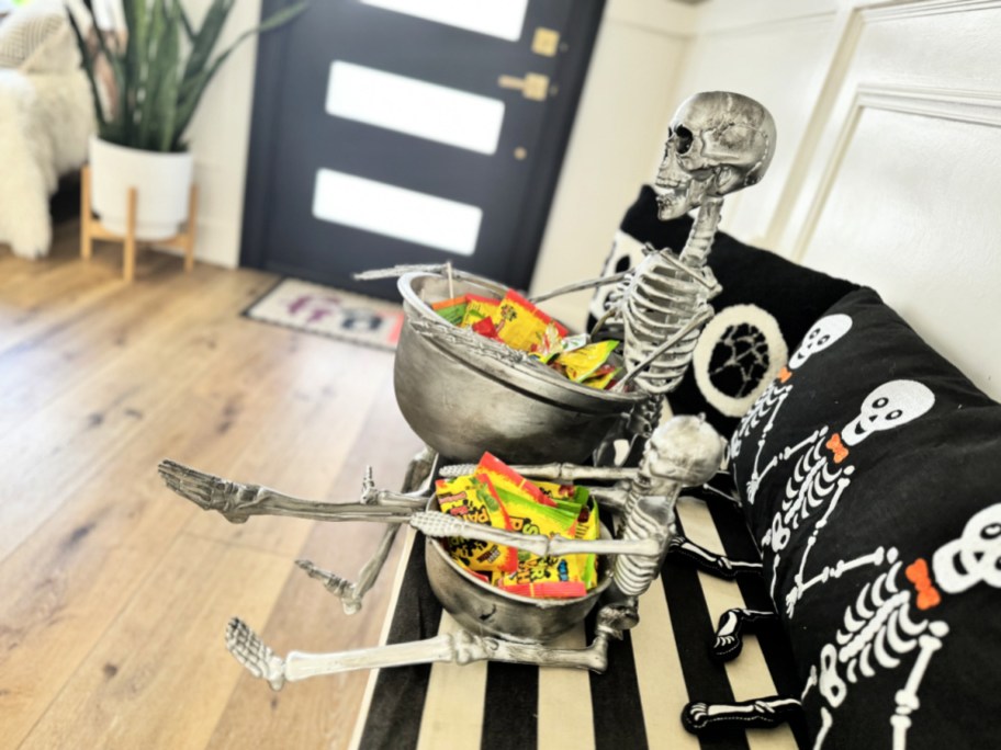 skeleton bowls by the front door with halloween candy 