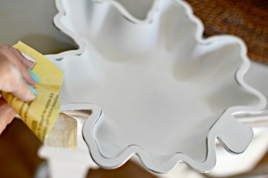 sanding the edges of painted dollar tree dish