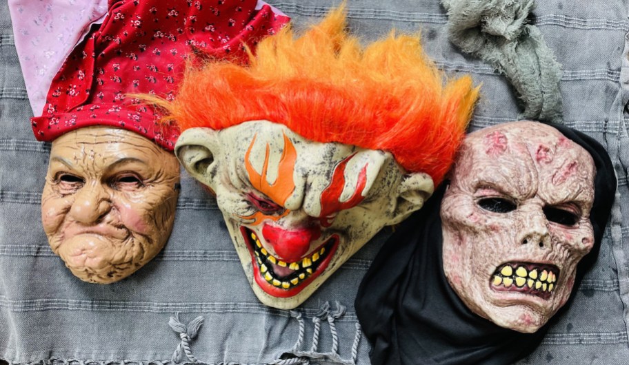 creepy halloween masks laying out to dry on blue towel