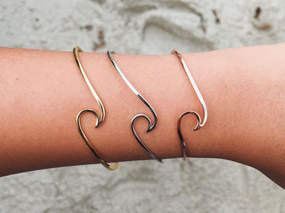 Pura Vida Gold Wave Cuff Bracelets on wrist