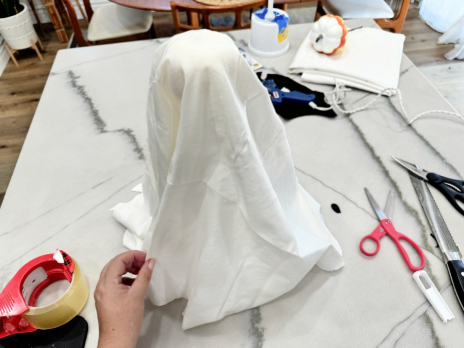 cutting up a pillowcase to make tabletop ghosts 