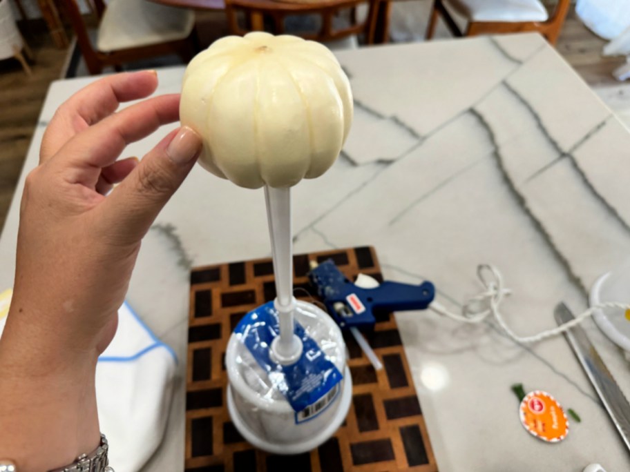 gluing a pumpkin to top of brush