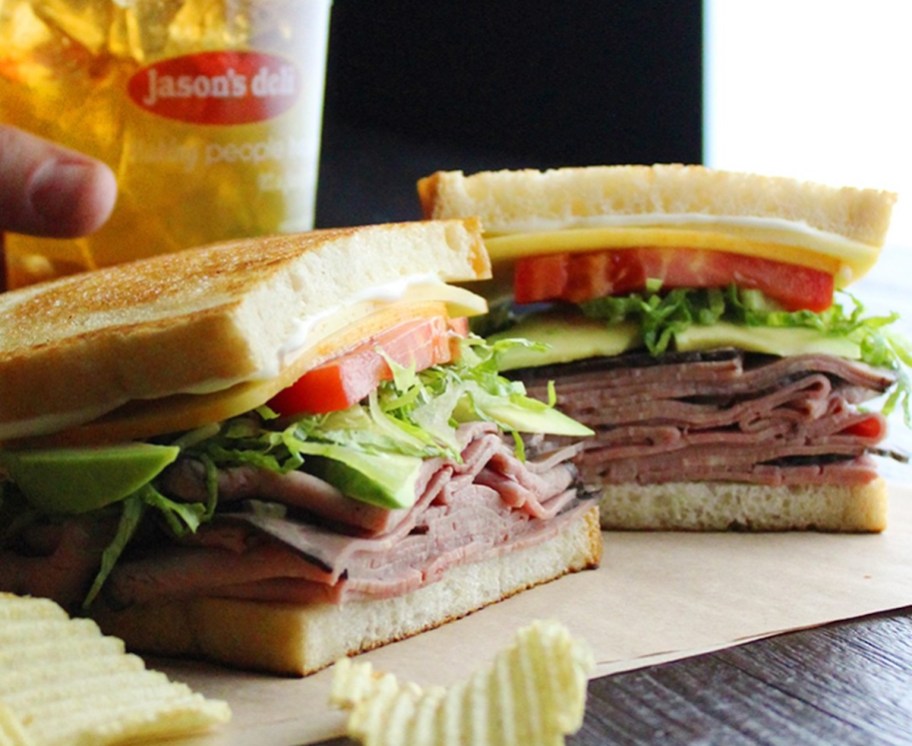 club sandwich on table with jason's deli plastic cup with tea good grades report card